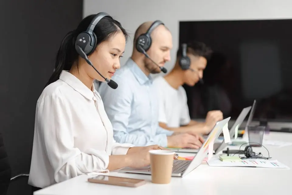 A support desk on headsets, working through the queue