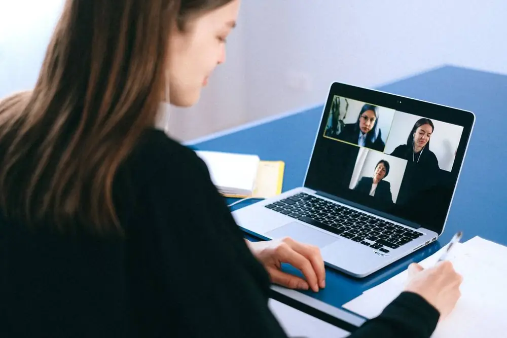 A remote call, with notes beside the laptop